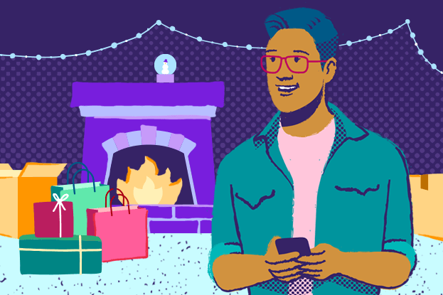 Man on phone with packages and gifts by a fireplace